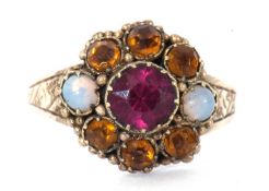 Antique cluster ring set with two small opals. orange and pink stones, raised between engraved