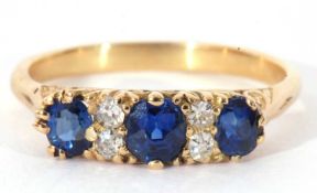 Sapphire and diamond ring featuring three oval faceted sapphires, highlighted between with four