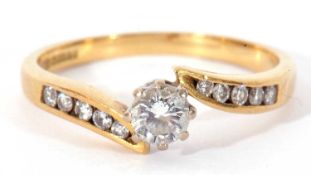 18ct gold single stone ring, a cross over design centring a round brilliant cut diamond, 0.20ct