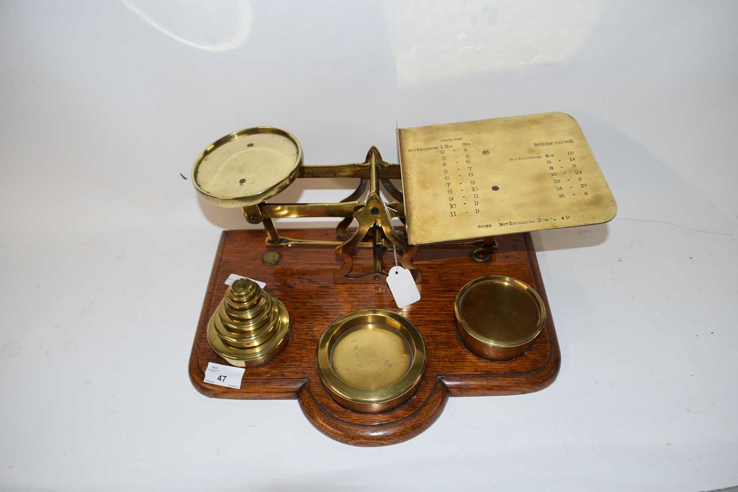VICTORIAN PARCEL SCALES WITH ACCOMPANYING WEIGHTS, SET ON A WOODEN BASE