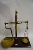 PAIR OF VICTORIAN BRASS BEAM SCALES TO WEIGH UP TO 2LB, SET ON A WOODEN PLINTH BASE