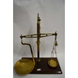 PAIR OF VICTORIAN BRASS BEAM SCALES TO WEIGH UP TO 2LB, SET ON A WOODEN PLINTH BASE