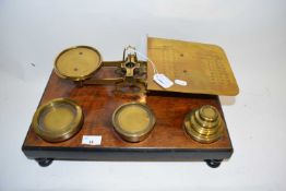 SET OF VICTORIAN POSTAL SCALES WITH ACCOMPANYING WEIGHTS SET ON A RECTANGULAR WOODEN STAND