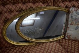 PAIR OF OVAL GILT FRAMED WALL MIRRORS