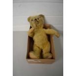 AN EARLY 20TH CENTURY STRAW FILLED TEDDY BEAR