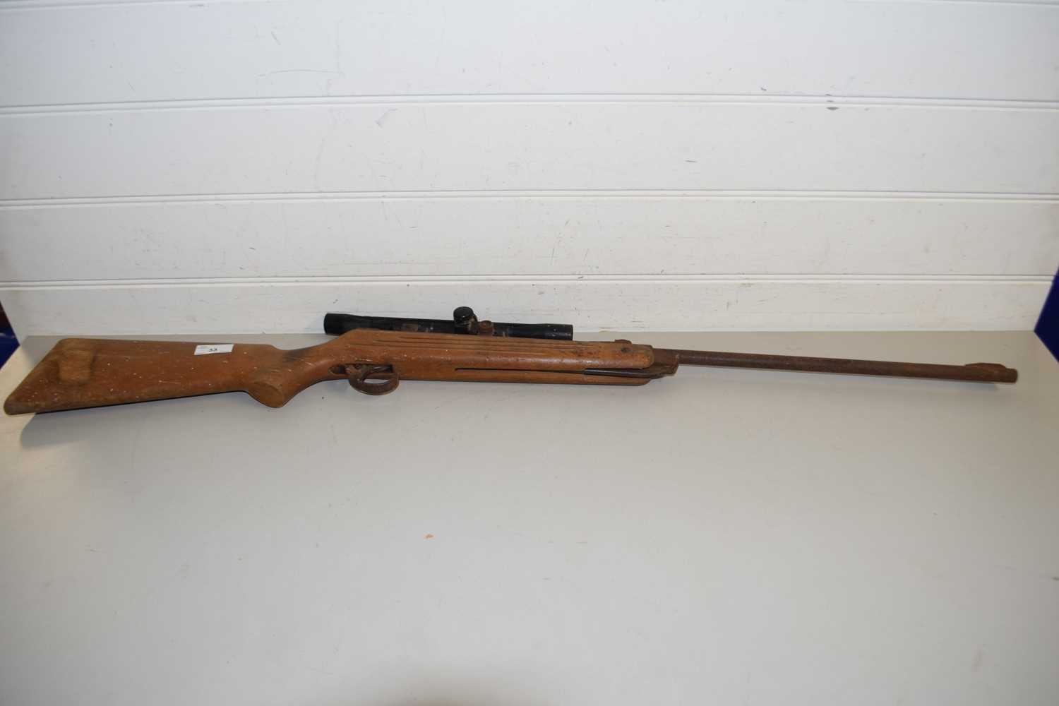 A VINTAGE AIR RIFLE WITH SCOPE