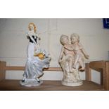 MODERN RESIN FIGURE OF A LADY WITH BASKET OF FLOWERS TOGETHER WITH A FURTHER RESIN FIGURE GROUP OF 2