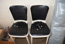 TWO WHITE METAL MID CENTURY CHAIR WITH BLACK UPHOLSTERY.