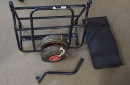 Trolly for transporting fishing equipment with a steel frame, sturdy wheels and a strong sturdy