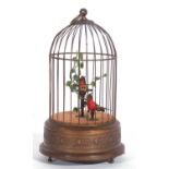 mechanical wind-up singing birds in a bird cage