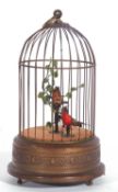 mechanical wind-up singing birds in a bird cage