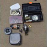 Mixed lot of fishing equipment to include line reels, reels, tools and weights etc