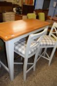 MODERN OAK BAR TYPE TABLE AND TWO ACCOMPANYING HIGH CHAIRS WITH CHEQUERED UPHOLSTERED SEATS