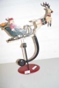GRAVITY DRIVEN ROCKING SANTA CLAUSE AND SLEIGH FIGURE