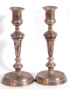 Pair of George V silver candle sticks with tapered columns, the sconces of urn form to a spreading