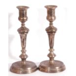 Pair of George V silver candle sticks with tapered columns, the sconces of urn form to a spreading