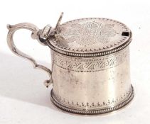 Victorian silver mustard pot of typical form decorated with beaded edges, the hinged lid with