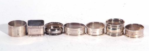 Group of seven hallmarked silver serviette rings of various dates/makers, 110 grams