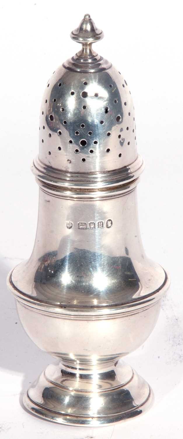 George V silver caster of typical form having a pierced pull off lid with an urn finial, plain