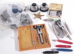 A set of watch maker tools. These include eye glasses, a case back opener, watch makers screw