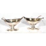 Two Georgian silver salts of Navette shape with reeded edges and small scroll thumb pieces raised on