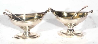 Two Georgian silver salts of Navette shape with reeded edges and small scroll thumb pieces raised on
