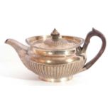 George III silver teapot of rounded form and part fluted detail with an applied gadrooned rim, on