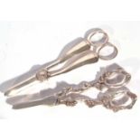 Pair of silver grape shears of plain pattern design, one blade with a serrated cutting edge and