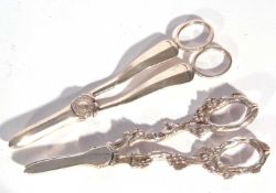 Pair of silver grape shears of plain pattern design, one blade with a serrated cutting edge and