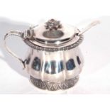 George IV silver mustard pot of circular octagonal form with a leafed cap, scrolled handle, dome