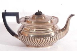 Edward VII silver teapot of oval form having a hinged lid with an ebonised finial, applied gadrooned