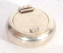 Vintage white metal portable ashtray of squat circular form, hinged lid opening to a cigarette