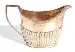 Edward VII silver cream jug of oval form with reeded angular handle and half fluted body, hallmarked