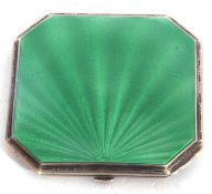 A Art Deco ladies silver and enamel compact of square canted form, the lid with a green guilloche