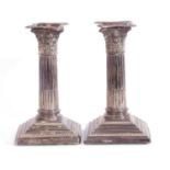 Pair of silver neo classical style corinthian column formed candle sticks having detachable beaded