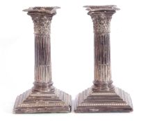 Pair of silver neo classical style corinthian column formed candle sticks having detachable beaded