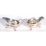Pair George VI silver sauce boats of typical form having flying scroll capped handles and