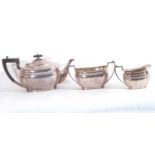 George V silver three piece tea set of plain form with cantered corners comprising teapot, twin