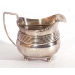 George III silver cream jug of typical form having an angular handle and reeded decorated body,