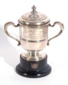 George V silver twin handle presentation trophy, the pull off cover with urn finial and the body