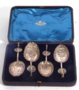A cased set of four continental silver embossed caddy spoons with figural detail bares a London 1894
