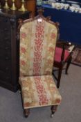 Victorian high back chair with carved frame and floral upholstery
