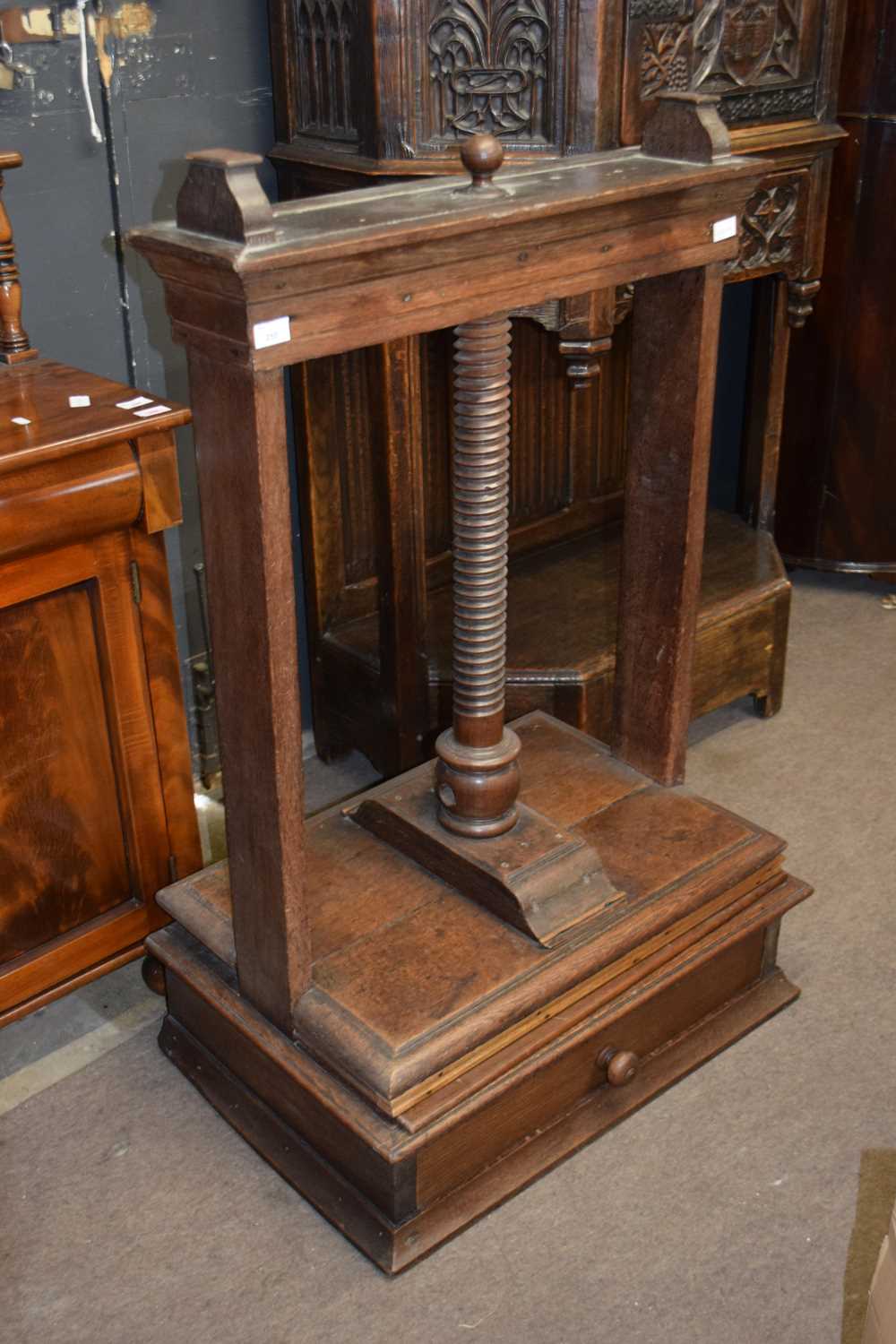 Georgian oak linen press cabinet formed of two sections the top section with screw wheel press