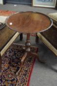 Mahogany wine table with circular tray top with pie crust edge over a turned column and tripod base,