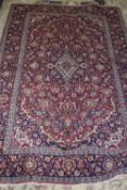 20th century Kashan wool floor rug, decorated with floral design and large central lozenge on a
