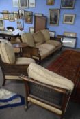 Late 19th Century mahogany framed bergere three piece suite comprising a three seater sofa and