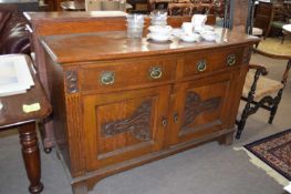 Late Victorian bow front side board with two drawers and two doors with carved stylised