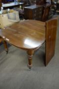 Victorian mahogany extending dining table raised on turned legs together with a single extension