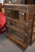 Globe Wernicke oak stacking book case on unusual form with beveled glass fitted to the doors and a