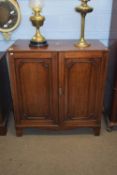 Georgian mahogany two door cupboard, the panel doors opening to a shelved interior supported on